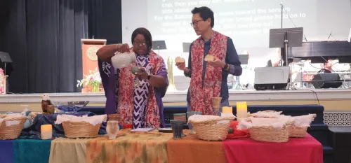 Rev. CeCe Armstrong and the Rev. Dr. William Yoo at communion table