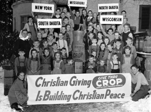 A group of German refugee orphans receiving food from the US in 1951. 