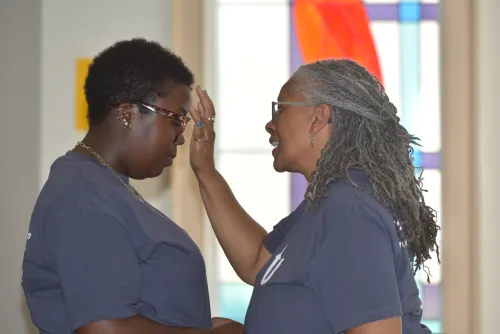 The Rev. British Hyrams, chaplain of Presbyterian College, anoints Nagwa Fokunang in worship at the inaugural UKirk Leadership Retreat.