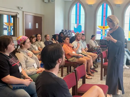 Indicating the space at the collarbone, Dr. Christine Roy Yoder guides students to consider where Hebrew philosophy locates the wisdom of nephesh (soul). (Photo by Beth Waltemath)