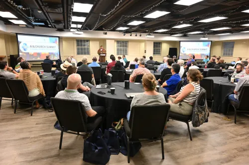 In person attendees at the AI & Church Summit listen to Cherban Kernell