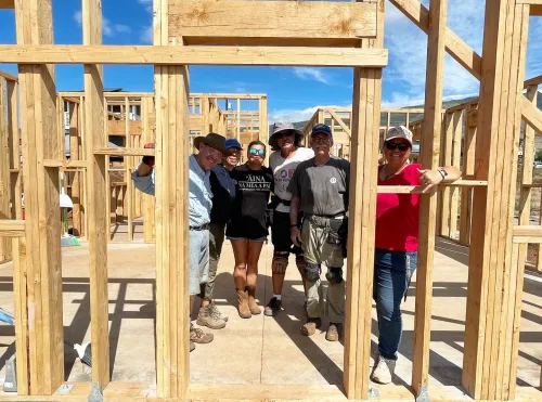 Volunteers and staff of the Lahaina Community Land Trust pose in the house they are building