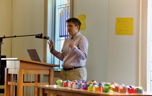 Due to a problem with the A/C, the Rev. Dr. Jenn Carlier takes off her suit jacket to discuss a theology of addiction with college students.