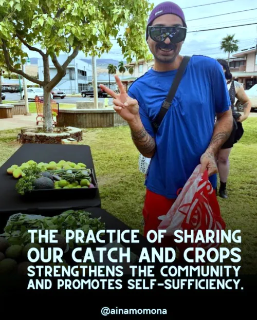 Guy giving peace sign holding a shopping bag and standing next to fresh produce