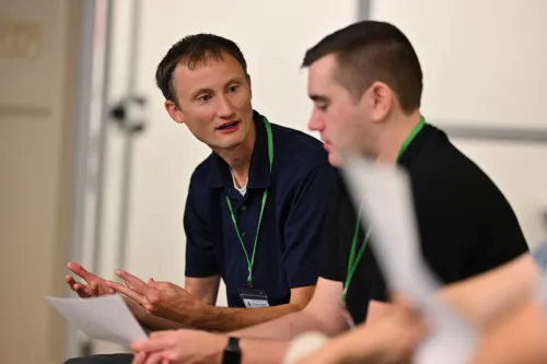 Rev. Michael Gewecki, co-pastor of First Presbyterian Church of Spirit Lake, IA, talks about AI with another attendee of the 2026 AI & Church Summit