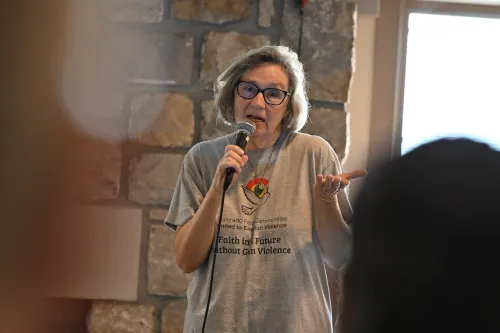 A woman speaks to a group 