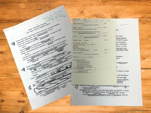 Two copies of Z Holler's sermon "Jesus 'Impossible' Possibility" laid out on a wooden desk.