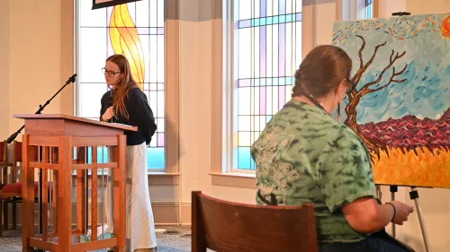 Olivia Phelps opens worship as Lauren Christian paints