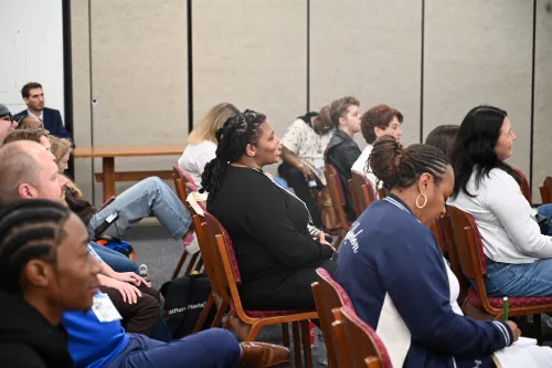 Participants at the Jesus and Justice Young Adult Advocacy Conference listen and laugh as the Revs. Aisha Brooks Johnson and Alonzo Johnson present. 