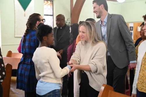 Ivy Lopedito, associate for the Office of Public Witness, passes the peace at Hillside Presbyterian Church. 