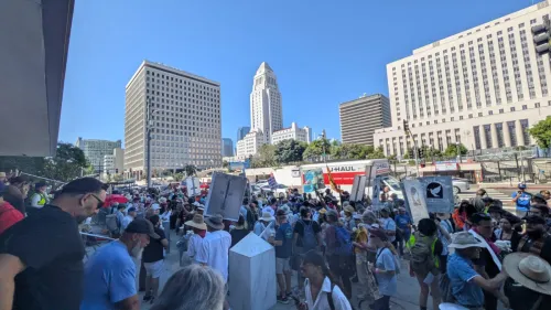 A group of people holding signs and protesting in a large city.