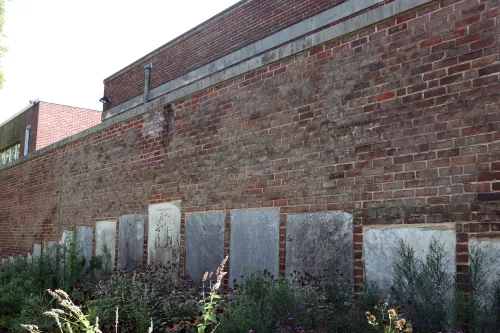 Photo of the line of tombstones embedded into the exterior wall of the Presbyterian Historical Society's building.
