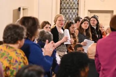 Young people standing up at church