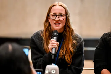 Woman speaking while holding a microphone