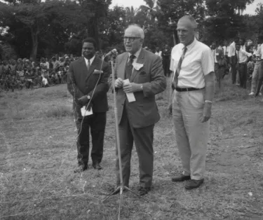 Black and white photograph taken during the integration of the American Presbyterian Congo Mission and the Eglise Presbyterienne au Congo. Dr. R. Matthew Lynn, Moderator of the Presbyterian Church in the U.S., speaks at celebration in Luebo, March 1970.