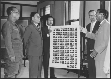Harold Voelkel and a handful of other churchmen from South Korea are pictured presenting “pictorial evidence of the growth of a native clergy from former Communist soldiers” to the President. “The display shows the pictures of 104 North Koreans, former prisoners of war who have embraced Christianity, graduated from religious training schools and entered fulltime Christian service"