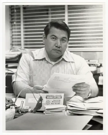 Cecil Corbett at desk.