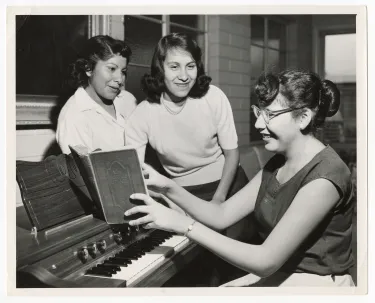 Cook Christian Training School students at electronic organ.
