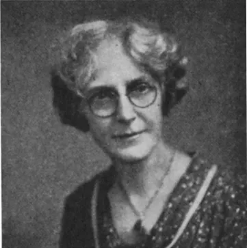 Black and white photo portrait of Sarah E. Dickson. She wears round spectacles and has hair cut above her shoulder.