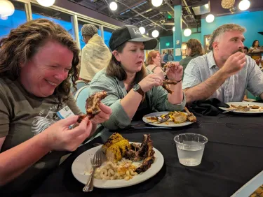 Three people eating dinner at the 40th anniversary celebration dinner in St. Louis