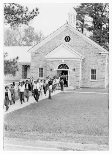 Boggs Academy students after chapel service exiting John I. Blackburn Presbyterian Church.