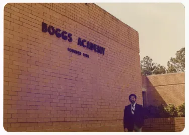 Yenwith K. Whitney, president of Boggs Academy, in front of Administration Building.
