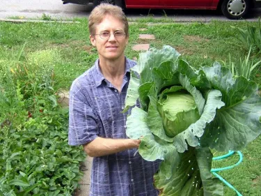 Andrew holding a giant cabbage from garden
