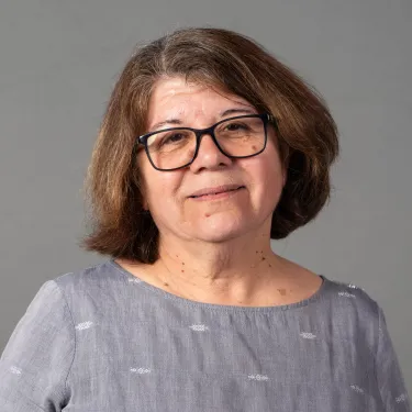 Portrait of woman in glasses and gray shirt