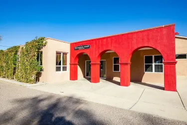 Rendon Hall at Menaul School in New Mexico. A bright red facade.