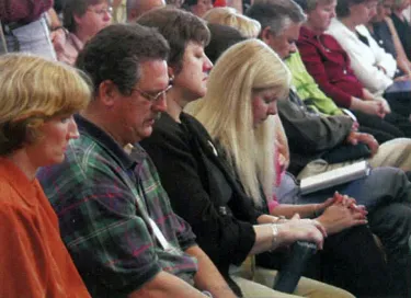 Image of staff members at the Presbyterian Center in Louisville, Kentucky, who crowded into the chapel for a somber and emotional prayer service Sept. 11.