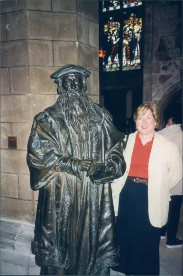 Adams stands by a statue of Protestant leader, John Knox at St. Gile's Cathedral in Edinburgh, Scotland.
