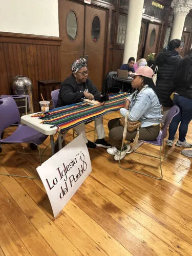 Arelis Figueroa meets with a woman at La Iglesia del Pueblo in Manhattan.