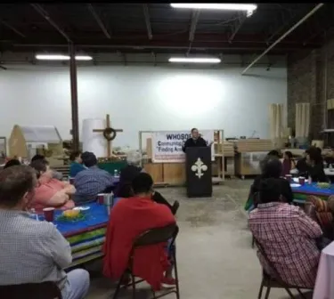 Rev. Dionne Boyice leading a prayer in a Friday Fellowship gathering of Whosoever in FAITH