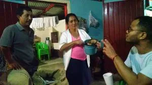 Robert Uribe (right), owner of Galiano's Café, visiting in the home of Lilia Velazquez and her son, David Cifuentes Velazquez. David, a Presbyterian elder, is another of the sons who have been able to return home because of Café Justo.