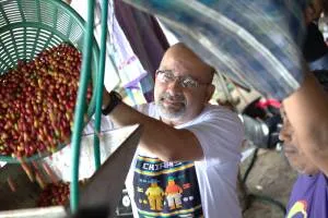 Danny Ortega depulping coffee with Adan Robero