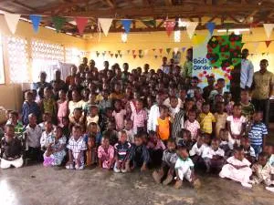 The children of one congregation in rural Ghana gathered around a banner (back right) that reads “God’s Garden”