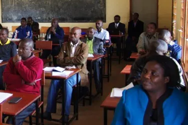 Students (background) at orientation of MA program, Dean J. Mlenga foreground