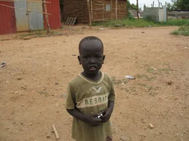 A future student at the first school building being built in partnership with the South Sudan Education and Peace Building Project