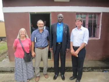 PCUSA mission co-workers Lynn and Sharon Kandel, Rev. Peter Gai, and Jim after a church service in Juba, South Sudan.