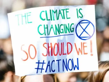 Sign that reads: The climate is changing. So should we! #Act Now.