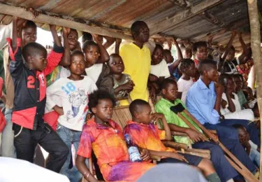 Three of the kids from Ditekemena (seated) accompanied us on a visit to a rural parish in January—standing-room only!