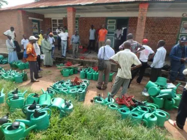 Community health workers receiving gardening tools