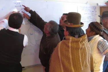 Communities mapping out the areas affected by mining contamination during a workshop facilitated by Dr. Fernando Serrano (Professor at St Louis University) in Oruro, Bolivia