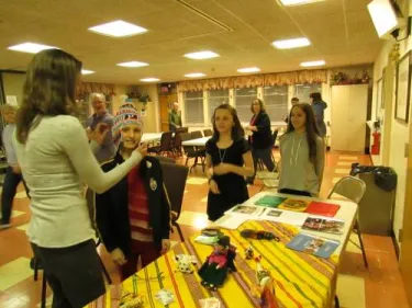 Showing youth of First Presbyterian Church of Succasunna (Newton Presbytery, N.J.) the Bolivian items on the display table during Interpretation Assignment in the U.S. **Photo taken by Michele Johnston (member of First Presbyterian Church of Succasunna)