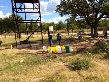 Students fetching water supplied by the solar borehole at Mnondu School