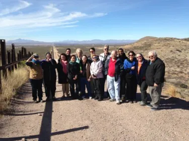 The Voices from the Border and Beyond group at the U.S. Border Patrol fence in Douglas, Arizona/Agua Prieta, Mexico