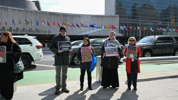 People with signs standing near United Nations