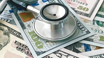 A picture of a stethoscope on top of a lot of US 100 and 50 dollar bills.