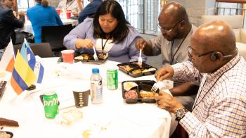 U.S.-based GEL, the Rev. Princeton Abaroaha, breaks bread with others at conference on new immigrant churches in April 2023.