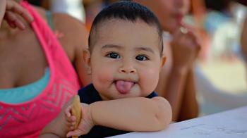 Baby sticks out tongue
